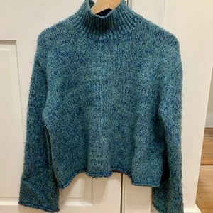 Blue turtle neck sweater with metallic strings